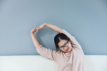 Asian woman stretching her arms.