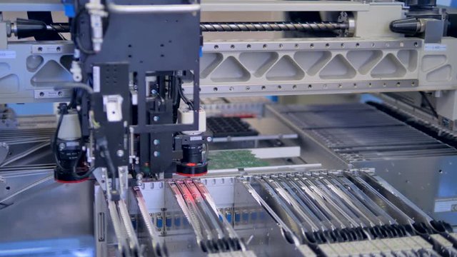 Automated robotic manufacturing PCB, modern equipment. 4K.