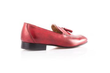 Close up of a red mens loafers on white background with reflection. Fashion advertising shoes...