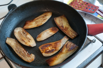 Sliced eggplant on frying pan