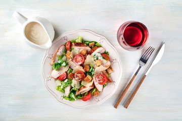 Chicken Caesar salad on light background with copyspace