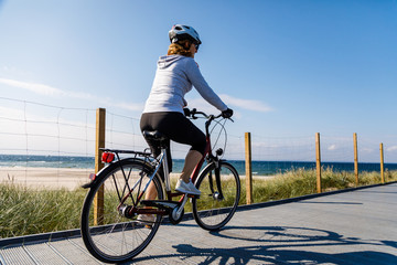 Healthy lifestyle - middle-aged woman riding bicycles 