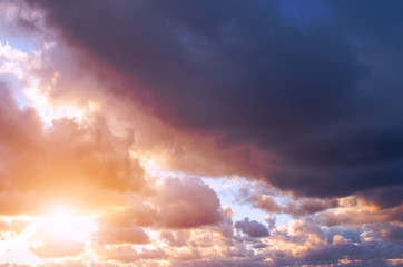 Dramatic clouds at sunset and the bright sun.