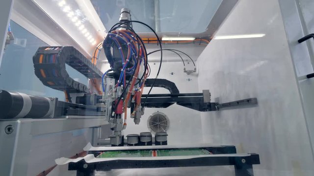 Robotics arm working on PCB production. 4K.