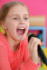 little girl singing with microphone