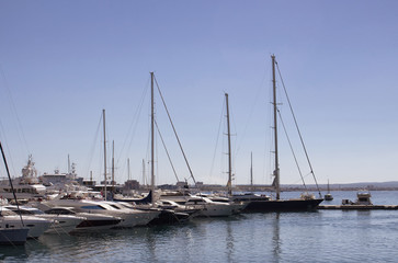 Fototapeta na wymiar View of many yachts parked at Palma de Mallorca marina. It's a resort city and capital of the Spanish island of Majorca in the western Mediterranean.