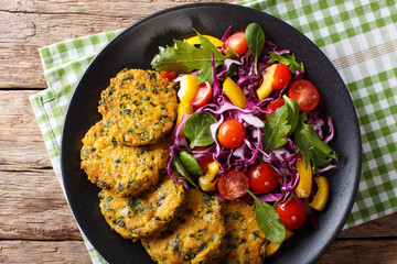 vegetarian quinoa burgers with spinach, carrots and fresh salad closeup on a plate. horizontal top view