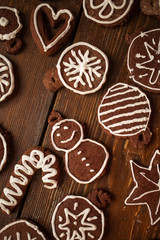 Traditional homemade Christmas ginger and chocolate cookies decorated with white sugar painting
