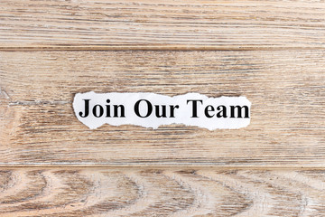join our team text on paper. Word join our team on torn paper. Concept Image
