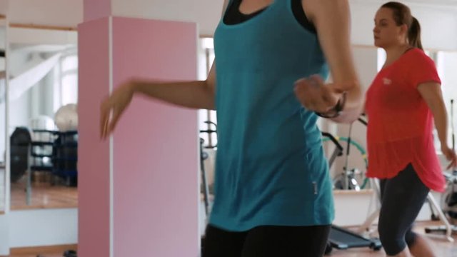 Zumba fitness coach training women in the gym. 