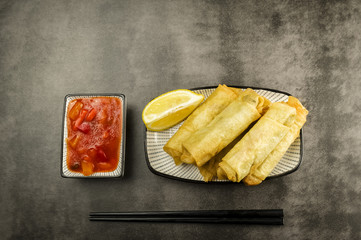 Spring rolls, chopsticks and sauce
