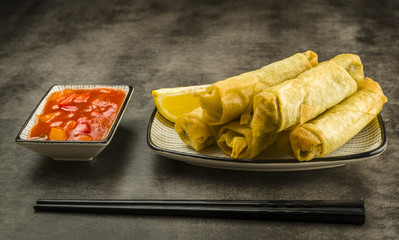 Spring rolls, chopsticks and sauce