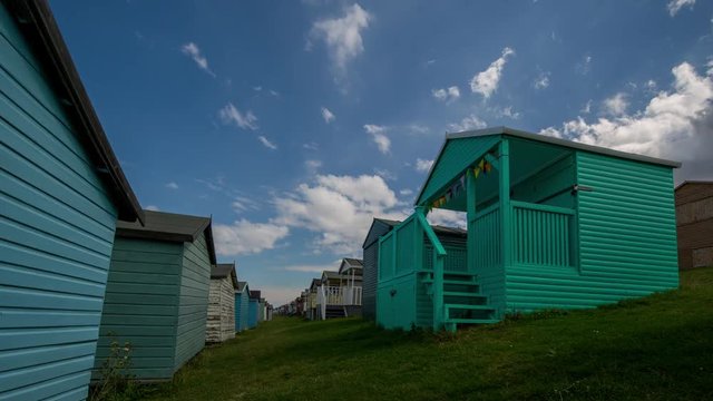 Time lapse of traditional english beach huts in whistable, kent, england on a summer's day