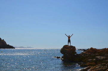 Man standing on rocks in the Calanques, Marseille