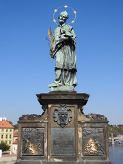 Fototapeta na wymiar Statue of Saint John of Nepomuk (Jan Nepomucký, John Nepomucene) on the Charles Bridge (Karlův most), city of Prague (Praha), Czech Republic (Česká republika)