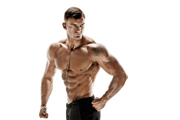 Tattooed muscular super-high level handsome man posing in studio isolated on white background