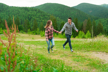 Fototapeta premium Young couple in love walking in mountains.