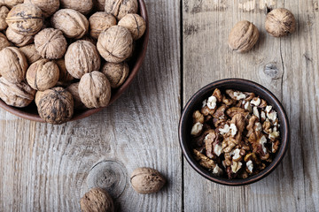 walnuts in a clay plate on a wooden background. top view