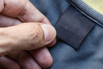 Close up hand hold clothing label