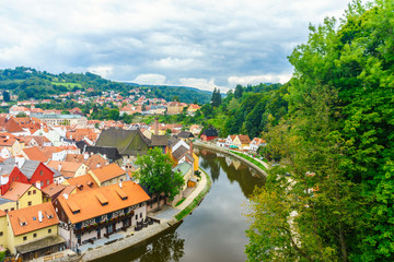 Fototapeta na wymiar Castle Krumlov and Cesky Krumlov. Medieval fortress and the river Vltava. Red tile and narrow streets. Houses made of stone. The Rim of the River