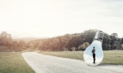 Businesswoman inside light bulb