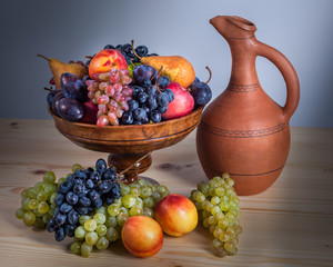 autumnal fruit still life with Georgian jug on rustic wooden table background