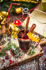 Red mulled hot wine in glass with spices