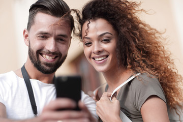 Young couple visiting city in summertime and looking photos