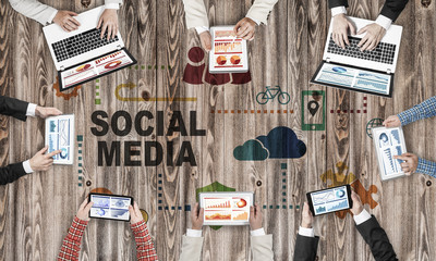 Top view of businesspeople sitting at table and using gadgets