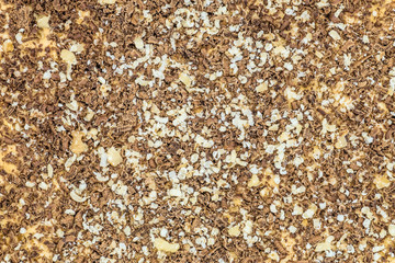 Surface of sweet dessert with nut and chocolate chips. Сonfectionary abstract background.