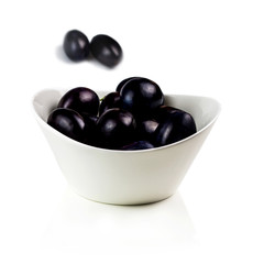 tasty plums in ceramic bowl