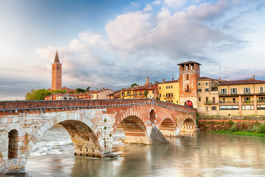 Famous Verona landmark. Ponte di Pietra over Adige river during sunrise.