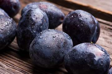 fresh plums on wooden background