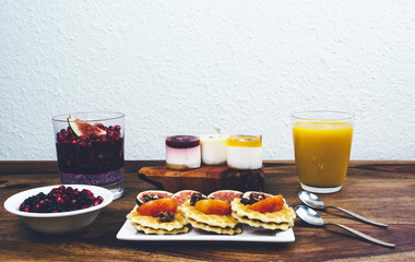 Healthy breakfast set on rustic wooden table.