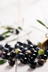 Fresh Black Olives On An Olive Branch With Leaves