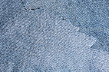 shreds of denim fabric, unevenly cut jeans