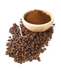 Coffee beans with ground coffee in wooden bowl