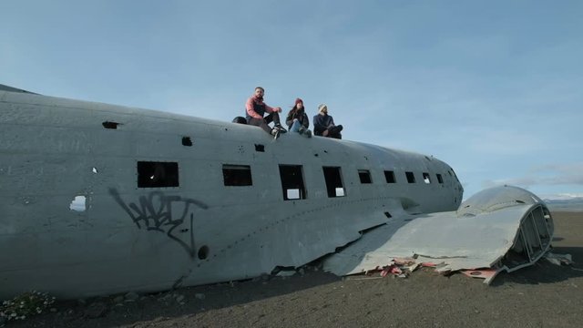 Wide panning shot of people exploring airplane wreckage Vestur-Skaftafellssysla, Iceland
