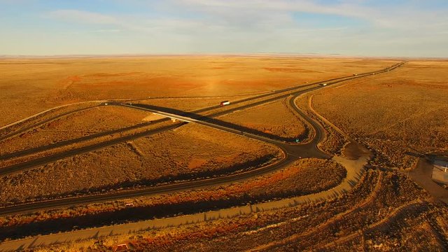 Golden Sunset Highway Cuts Through Desert Landscape