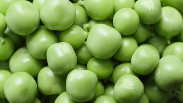 Fresh green peas rotate. Top view. Close up