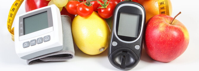Glucometer for checking sugar level, blood pressure monitor, fruits with vegetables and centimeter,...