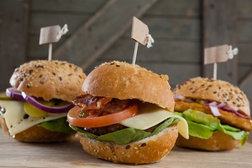 Various hamburger with tag on wooden table