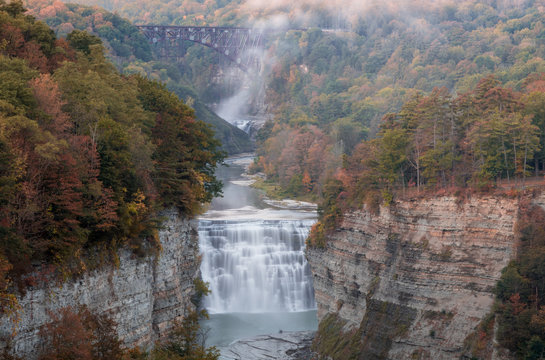 Early Autumn colors at dusk surround the majestic Middle and Upper Waterfalls of Letchworth State Park, NY