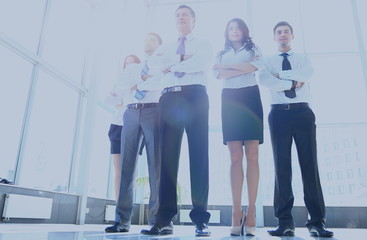 Portrait of businessman leading his team at office