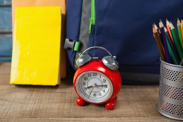 Bagpack, books, alarm clock and pen holder