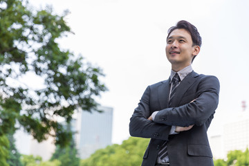 portrait of young asian businessman in park