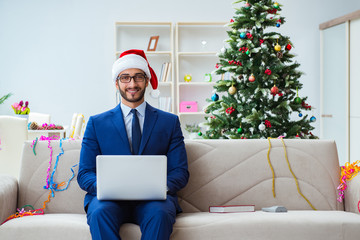Businessman working at home during christmas
