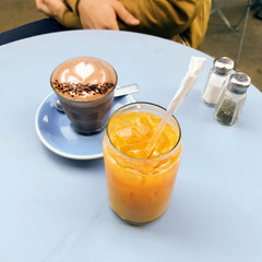 Juice and hot chocolate at a table