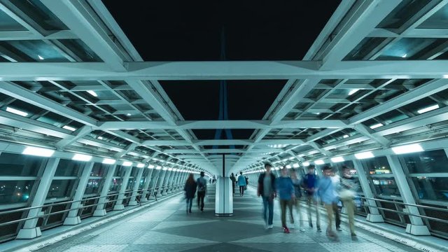 Zooming timelapse footage of people walking at futuristic passageway in Odaiba, Tokyo, Japan
