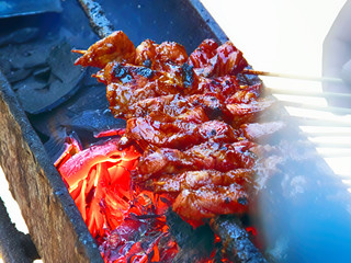 Satay on the grill with air blowing from a fan